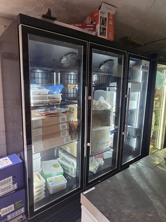 Three-door commercial glass display freezer in used condition